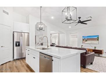 Bright kitchen featuring white cabinets, stainless steel appliances, and modern lighting fixtures at 17827 N 51St Way, Scottsdale, AZ 85254