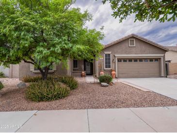 Charming single-story home featuring a well-maintained landscape and a two car garage at 22986 S 208Th St, Queen Creek, AZ 85142