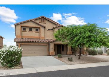 Charming two-story home with desert landscaping, a two-car garage, and a welcoming front porch at 3022 N Lainey Ln, Buckeye, AZ 85396