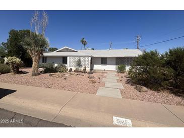 Charming single-story home with decorative concrete accents and a well-maintained desert landscape at 3125 N 82Nd Pl, Scottsdale, AZ 85251