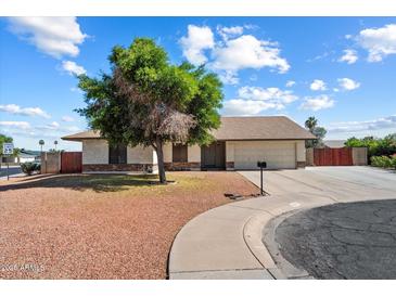 Charming single-story home featuring a well-maintained front yard and an attached two-car garage at 6614 S Mckemy St, Tempe, AZ 85283