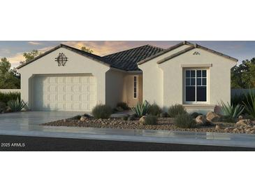 Beautiful one-story stucco home featuring desert landscaping, a two-car garage, and a tiled roof at 10155 W Columbus Ave, Avondale, AZ 85392