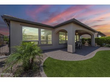 Enjoy outdoor living with this home's covered patio, paved with brick and perfect for entertaining at sunset at 116 E Santa Lucia Ln, Queen Creek, AZ 85140