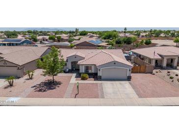 Charming single-story home with well-manicured landscaping and a spacious two-car garage at 15019 W Banff Ln, Surprise, AZ 85379