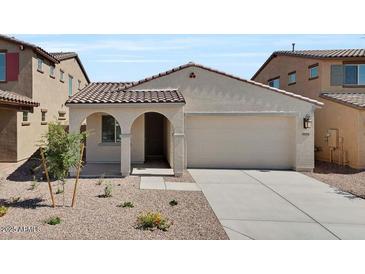 Charming single-story home features a tile roof, stucco facade, and a two-car garage at 16784 W Hope Dr, Surprise, AZ 85388