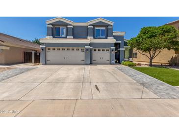 Inviting two-story home with a large driveway and attached two-car garage at 3545 W Tanner Ranch Rd, San Tan Valley, AZ 85144