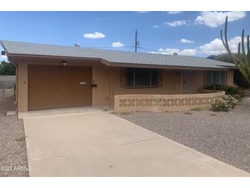 Charming single-story home featuring a desert landscaped front yard and a covered front entrance at 5702 E Casper Rd, Mesa, AZ 85205