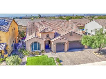 Beautiful single-Gathering home with a tile roof, manicured lawn, and a three-car garage at 710 W Ardmore Rd, Phoenix, AZ 85041