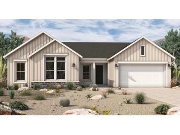 Charming single-story home featuring stone accents and a two-car garage in a well-manicured desert landscape at 953 W Ridge Rd, Apache Junction, AZ 85120