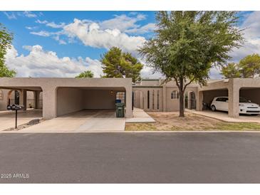 Beige single-story home featuring carports and desert landscaping at 1173 E Cochise Dr, Phoenix, AZ 85020