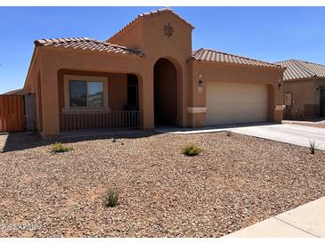 Charming single-story home with a desert-landscaped front yard and an attached two-car garage at 1223 E Palo Verde Dr, Casa Grande, AZ 85122