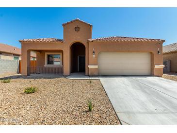Charming single-story home featuring a tile roof, low-maintenance landscaping, and attached two-car garage at 1223 E Palo Verde Dr, Casa Grande, AZ 85122