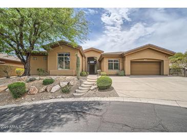 Charming single-story home featuring desert landscaping and a private two-car garage at 12448 N 129Th Pl, Scottsdale, AZ 85259