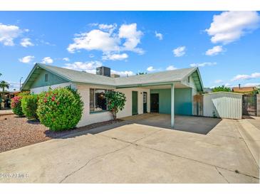 Charming single-story home featuring a covered parking area, well-maintained landscaping, and painted brick at 4346 W Mescal St, Glendale, AZ 85304
