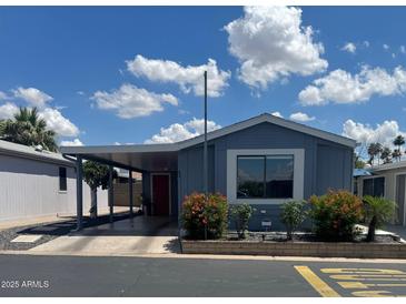 Charming single-story home with well-maintained landscaping and convenient carport at 5735 E Mcdowell Rd # 63, Mesa, AZ 85215