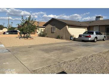 A single-story home featuring a low-maintenance xeriscaped front yard and a two car garage at 8307 W Indianola Ave, Phoenix, AZ 85037