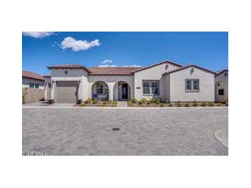Charming single-story stucco home with a tile roof and an arched entryway at 11249 N Blakely St, Surprise, AZ 85388