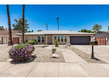 Charming single-story home with well-maintained landscaping and a two-car garage at 2062 S Emerson --, Mesa, AZ 85210