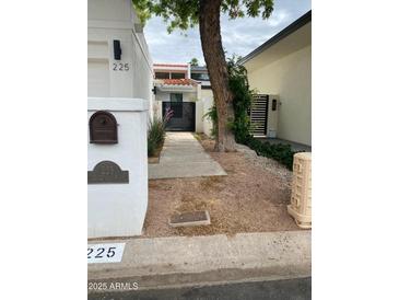 Landscaped entry to home with mailbox, address, and modern horizontal slat privacy screen at 225 W Winged Foot Rd, Phoenix, AZ 85023
