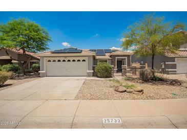 Charming single-story home featuring a two-car garage, solar panels, and desert landscaping at 25732 W Elizabeth Ave, Buckeye, AZ 85326