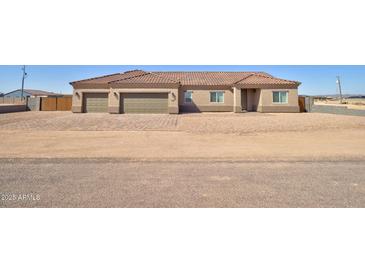Inviting single-story home featuring a three-car garage and well manicured landscape in a rural setting at 3850 N Mateo Dr, Eloy, AZ 85131