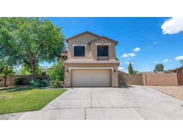 Charming two-story home with a well-manicured lawn and inviting curb appeal on a sunny day at 5787 W Barbara Ave, Glendale, AZ 85302