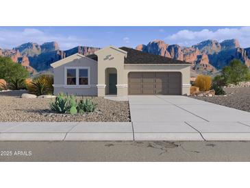Charming single-story home featuring desert landscaping and a two-car garage, set against a stunning mountain backdrop at 5842 E Axle Ln, San Tan Valley, AZ 85140