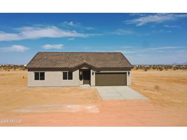 Charming single-story home featuring desert landscaping and a neutral color scheme at 5937 N Nigal Rd, Casa Grande, AZ 85194