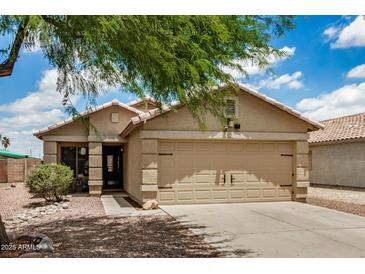 Charming single-story home with a two-car garage and desert landscaping at 6638 W Nez Perce St, Phoenix, AZ 85043