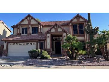 Charming two-story home with a two-car garage and desert landscaping at 6928 W Oraibi Dr, Glendale, AZ 85308