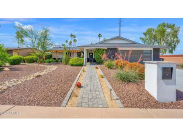 Charming home with desert landscaping, brick walkway and fresh exterior paint at 8730 E Montecito Ave, Scottsdale, AZ 85251