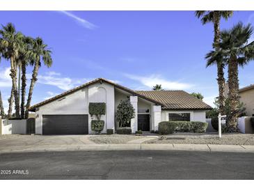 Charming single-story home with a tile roof, manicured landscaping, and a two-car garage at 1441 W Sea Haze Dr, Gilbert, AZ 85233