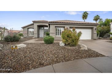 Charming single-story home featuring a neutral color palette, low-maintenance landscaping, and a two-car garage at 15064 N 54Th Way, Scottsdale, AZ 85254