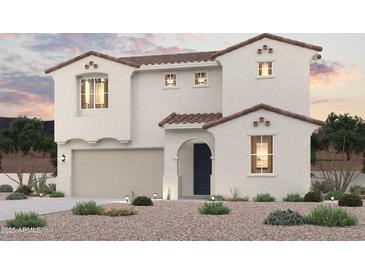 Two-story home featuring a desert-landscaped front yard, a garage, and a classic tile roof at 18058 W Creedance Blvd, Surprise, AZ 85387