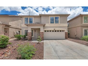 Charming home featuring a two-car garage and desert landscaping for low maintenance living at 1821 E Patrick Ln, Phoenix, AZ 85024