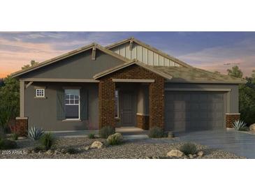 Charming single-story home features a stylish brick facade and a two-car garage at 20747 E Arroyo Verde Dr, Queen Creek, AZ 85142