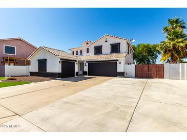 Two-story home featuring a three-car garage and well-manicured landscaping at 3444 E Flamingo Ct, Gilbert, AZ 85297