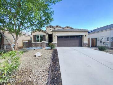 Charming single-story home featuring a well-maintained front yard and a two-car garage at 42099 W Balsa Dr, Maricopa, AZ 85138