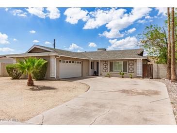 Charming single-story home with desert landscaping, a two-car garage, and a curved driveway under a partly cloudy sky at 4410 S Grandview Ave, Tempe, AZ 85282