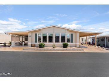 Inviting single-story home featuring covered patios, manicured landscaping, and a welcoming facade at 5735 E Mcdowell Rd # 388, Mesa, AZ 85215