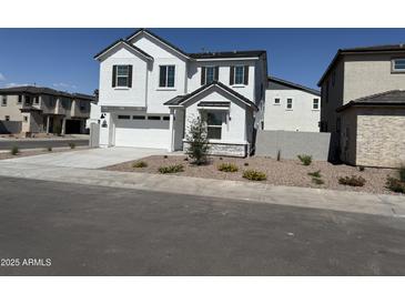 Charming two-story home with white stucco and dark trim, complemented by a landscaped front yard at 645 N Vine St, Chandler, AZ 85225
