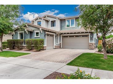 Beautiful two-story home featuring a three-car garage and manicured front lawn at 7528 E Peralta Ave, Mesa, AZ 85212