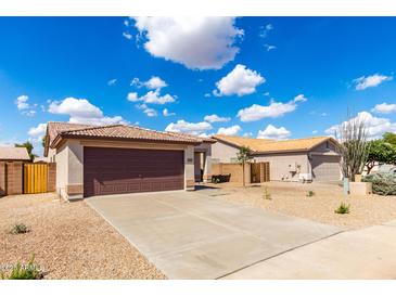 Charming single-story home featuring a two-car garage, low maintenance landscaping, and tile roof at 9332 W Mary Ann Dr, Peoria, AZ 85382