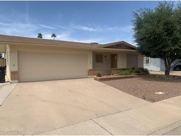 Charming single-story home with desert landscaping, two car garage and front yard at 108 E Jasmine St, Mesa, AZ 85201