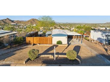 Well-maintained front yard with desert landscaping, a privacy fence, and a covered parking area at 13013 N 18Th St, Phoenix, AZ 85022