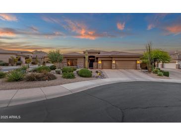 Beautiful single story home at dusk with desert landscaping, warm lighting, and an inviting driveway at 14708 E Canyoncrest Ct, Fountain Hills, AZ 85268