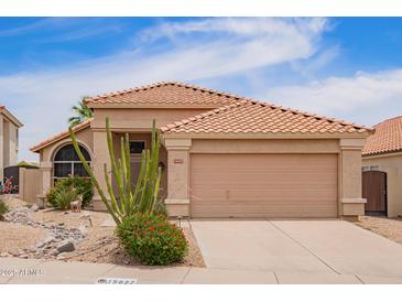 Charming single-story home featuring a well-maintained yard with desert landscaping and a neutral color palette at 15827 S 12Th Pl, Phoenix, AZ 85048