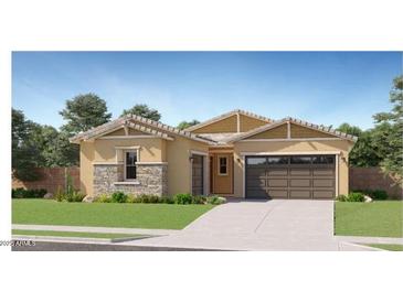 Charming single-story home featuring a two-car garage, desert landscaping, and neutral color palette at 17539 W Victory St, Goodyear, AZ 85338