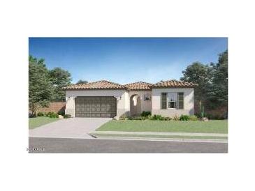Charming single-story home featuring a tile roof, arched entryway, and a well-manicured lawn at 17545 W Victory St, Goodyear, AZ 85338