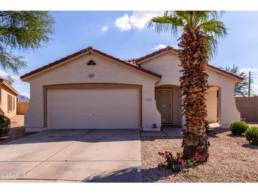 Charming single story home with a two car garage, desert landscaping, and a cozy front porch at 2635 W Atlanta Ave, Phoenix, AZ 85041